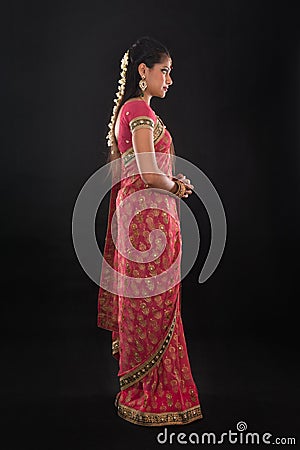 Full body side view of traditional young Indian girl