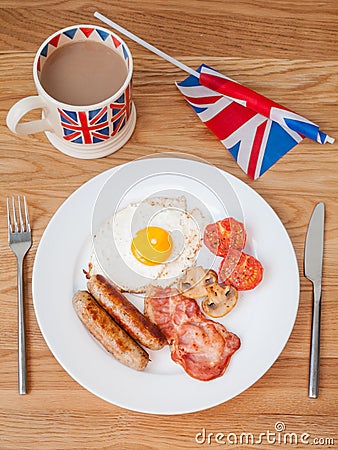 Full english breakfast with cup of tea and british flag