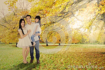 Full length of family under autumn tree