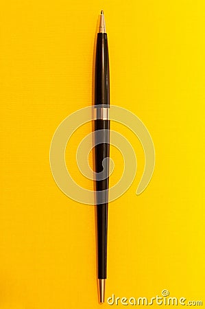 Full length luxury pen on yellow background