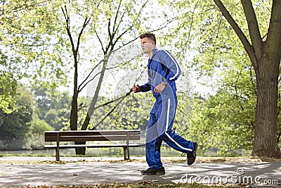 Full length side view of man jogging on path in park