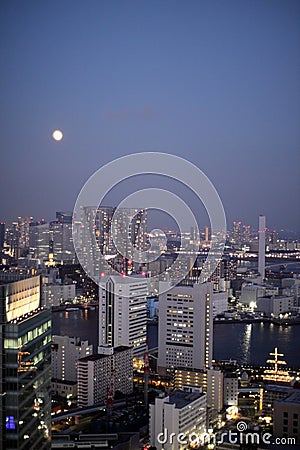 Full moon and illuminated buildings in Tokyo