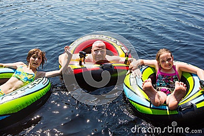 Fun in inflatable tubes swimming in the lake