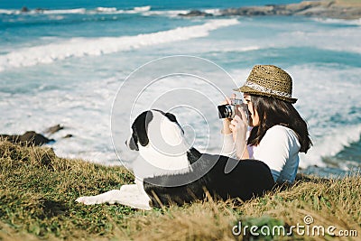 Funky woman taking photo to her dog