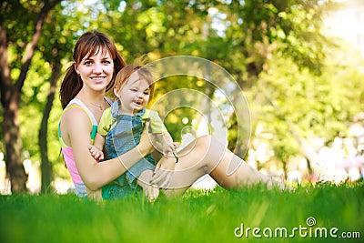 Funny baby with mom in park