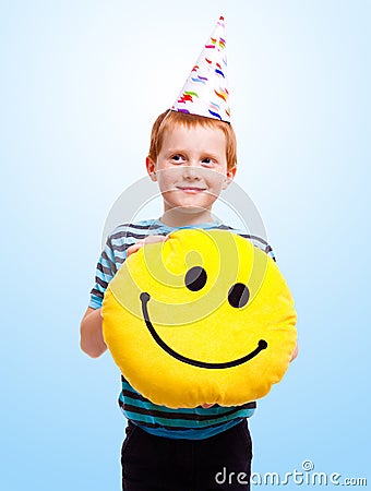 Funny boy in birthday cap on blue background