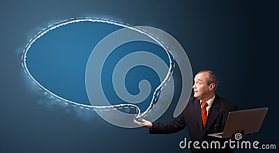 Funny businessman holding a laptop and presenting speech bubble