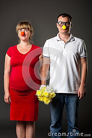 Funny couple with funny noses and bunch of flowers