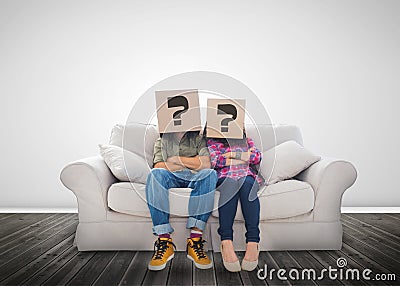 Funny couple wearing boxes with question mark on their head