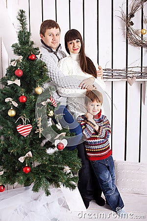 Funny family near the Christmas tree.