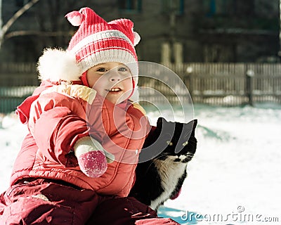 Funny happy child playing with cat.