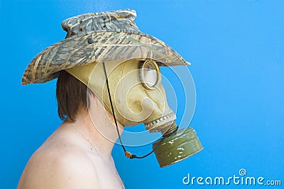 Funny portrait of man with gas mask and hat