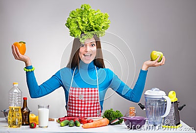 Funny portrait of a woman with the salad on her head
