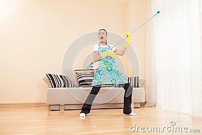 Funny woman mopping floor and playing.