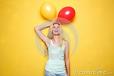 Funny young woman laughing with balloons