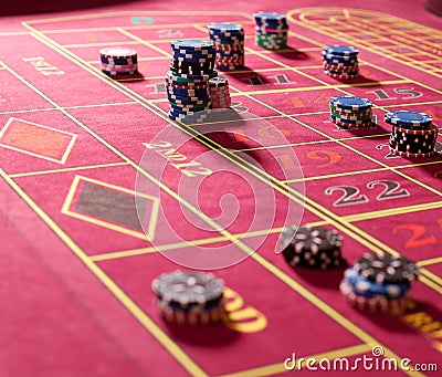 Gambling chips on red roulette table