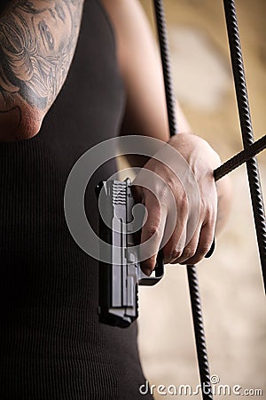 Gangster man standing and holding gun.