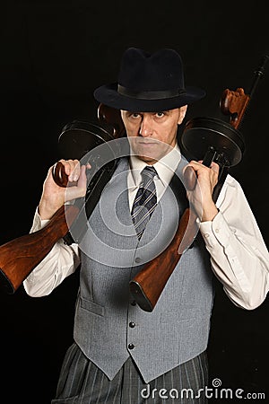 Gangster man in suit with gun