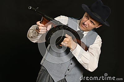 Gangster man in suit with gun