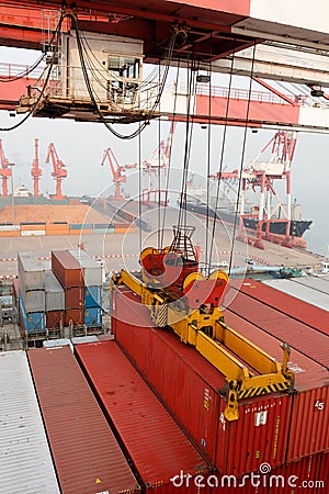 Gantry crane loads container onto freighter ship