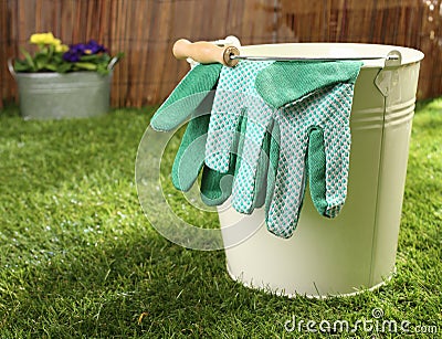Garden gloves on a metal bucket