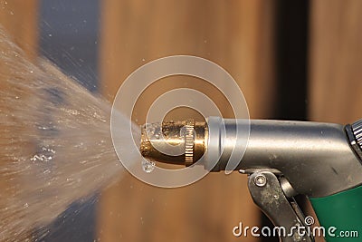 Garden hose spraying water with water droplet