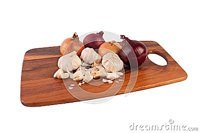 Garlic and onions on cutting board. Isolated on white.