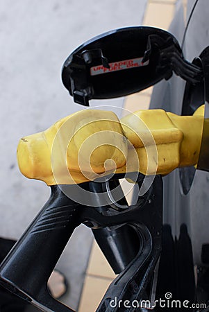 Gas Station Pump Nozzle in Car Tank Filling Intake