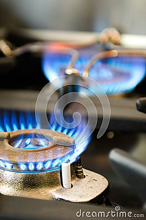 Gas stove with two burning blue flames