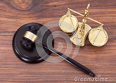 Gavel and scales with money on desk