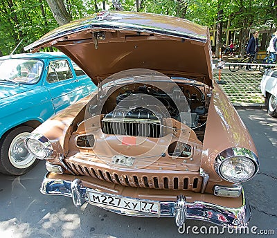 The GAZ-21 Volga car with an open motor compartment on show of retro cars