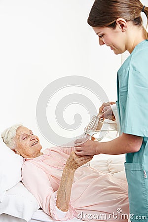 Geriatric nurse giving water