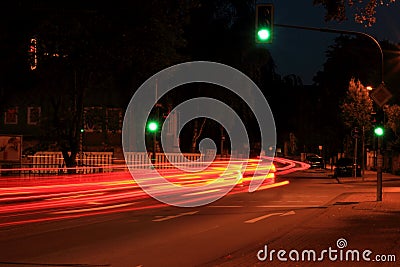 German night city street with green traffic light