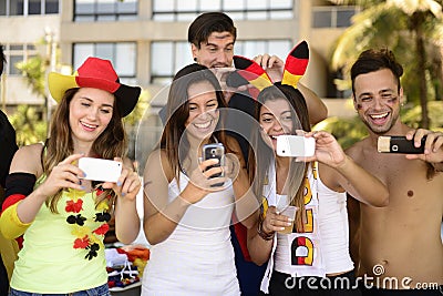 German soccer fans holding smartphones