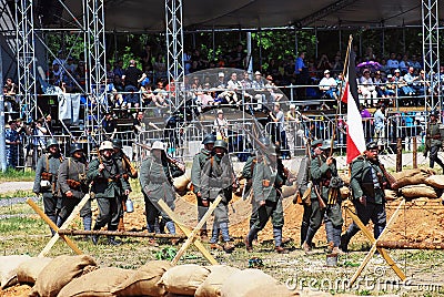 German soldiers march with a flag.