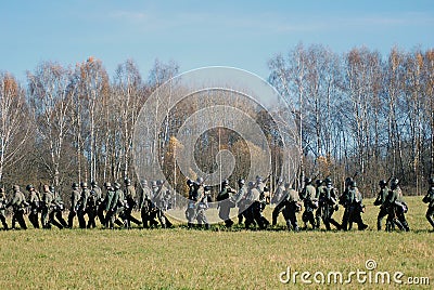 German soldiers-reenactors walk with guns