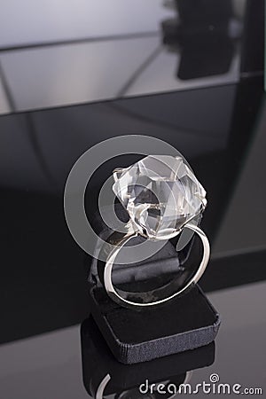 Giant engagement ring too big for ring case. black background