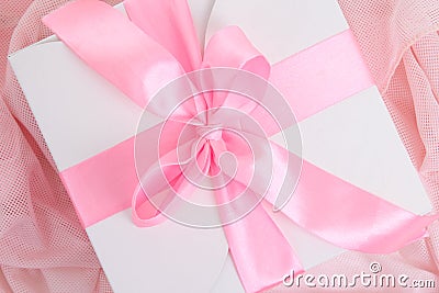Gift box with pink ribbon and bow