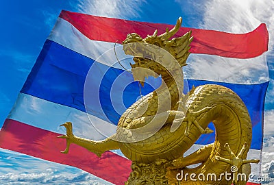 Gilded dragon statue with Thai Flag background