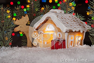 Gingerbread house with gingerbread man, elk and christmas trees