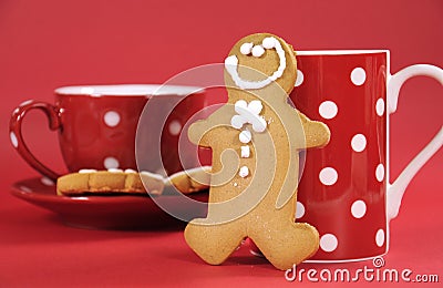 Gingerbread man with red polka dot coffee mug and tea cup