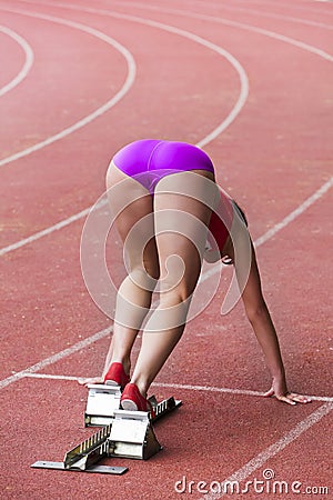 Girl athlete preparing to start