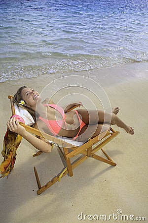 Girl in bikini on a beach chair