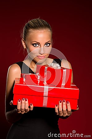 Girl in a black dress with gifts in hands