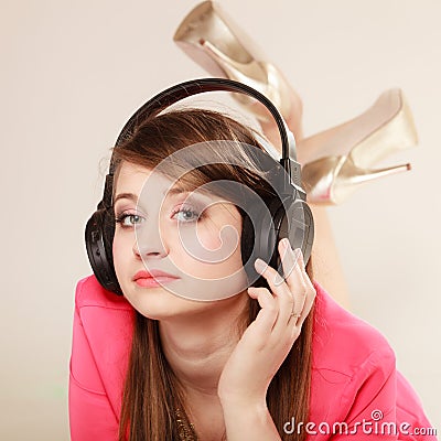 Girl with black headphones listening to music