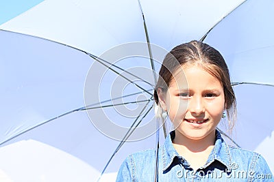 Girl in blue with white umbrella