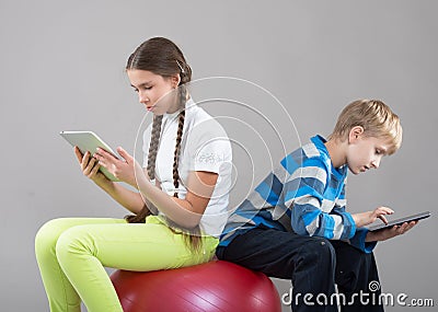 Girl and boy looking at Pad Tablet PC screens
