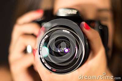 Girl with camera, closeup lens