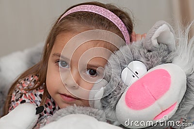 Girl with cat soft toy