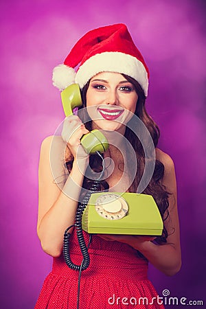 Girl in christmas hat with green telephone